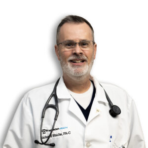 Richard Shults, PA-C, smiling and wearing a white Franciscan Health lab coat with a stethoscope around his neck.